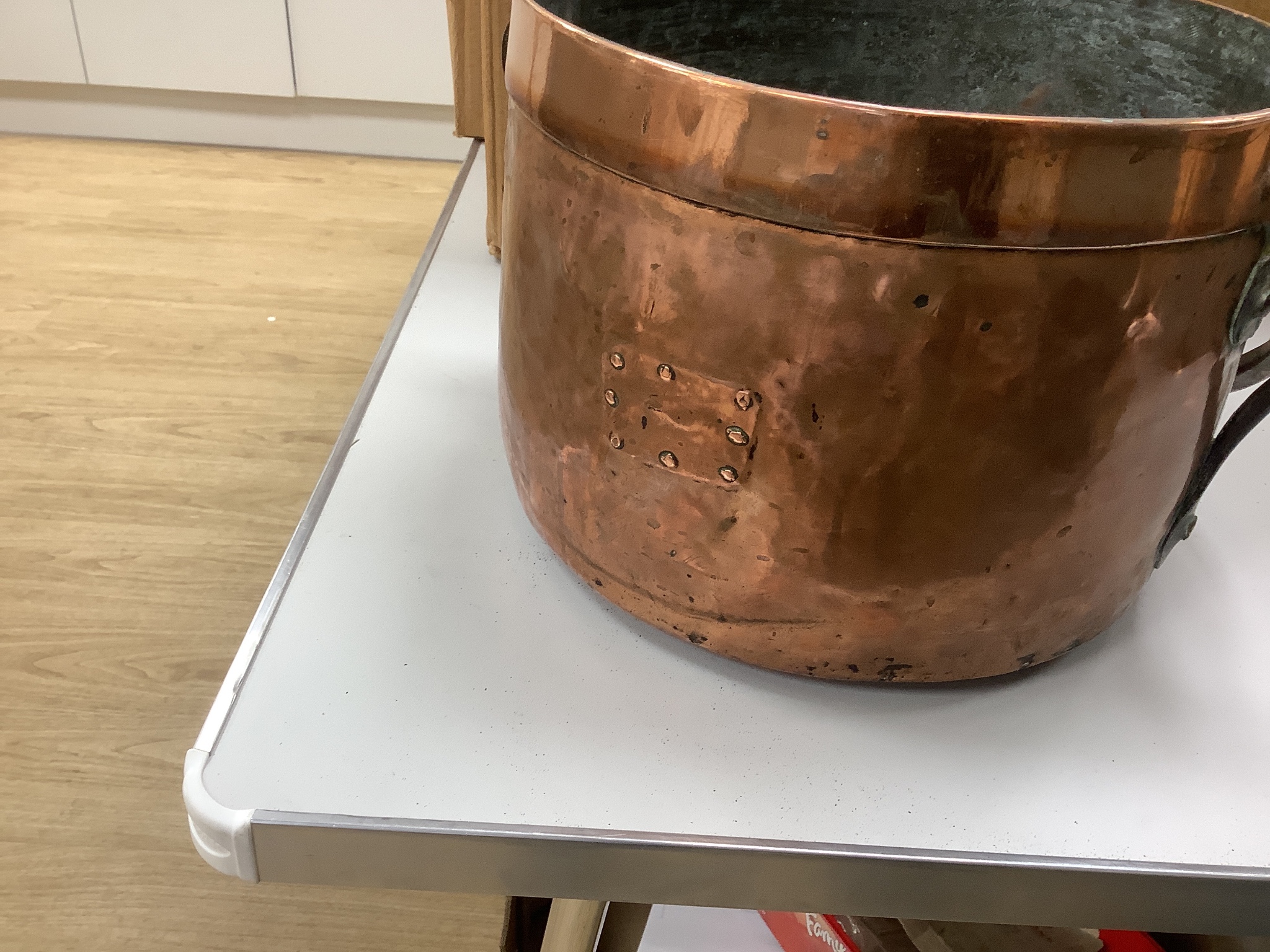 A French copper cooking pot and cover with swing handle, 27cm high